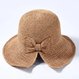 Elegant wide brim straw sun hat with a large decorative bow for summer UV protection