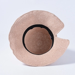Pink straw sun hat with wide brim and bow, featuring a ponytail-friendly open back design