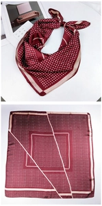 Close-up of wine red polka dot silk scarf with elegant geometric lines and satin texture