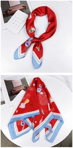 Detail of red square silk scarf featuring blue borders and modern lifestyle illustrations