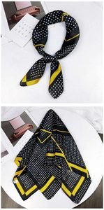 Detail view of square silk scarf with black yellow borders and white polka dots