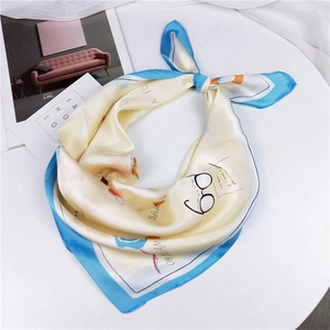 Elegant square silk scarf with light yellow base, blue border and artistic eyewear prints