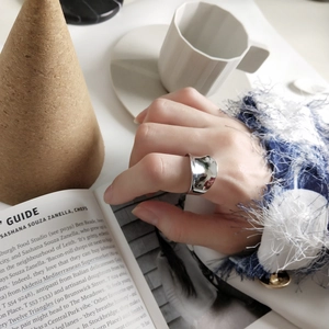 Minimalist 925 sterling silver irregular wide ring shown in a stylish lifestyle scene