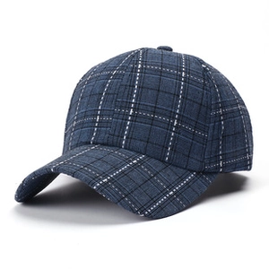 Detail view of the navy blue plaid pattern and fabric texture on a cotton baseball cap