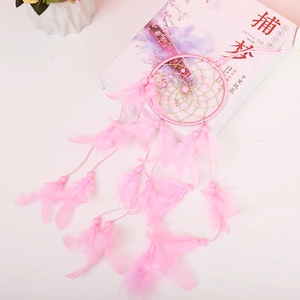 Pink bohemian dreamcatcher featuring feathers and golden beads for home wall hanging decor