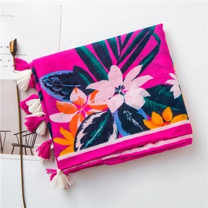 Detail of rose pink tropical leaf print cotton linen scarf with colorful fringe tassels
