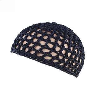 Detailed texture of dark blue hand-crocheted hair net cap with mesh hollow structure