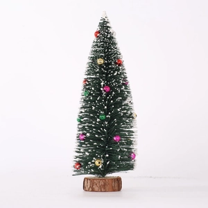 Miniature flocked Christmas tree with colorful ornaments and a natural wooden base