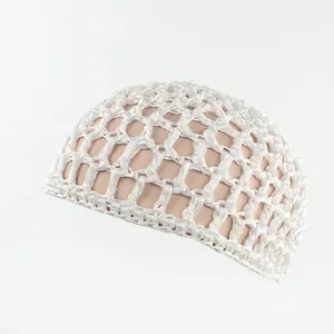 Close-up of white crochet hairnet with large mesh and bow detail on a mannequin