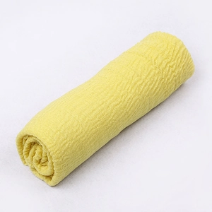 Detailed view of yellow crinkle cotton linen scarf showing soft pleated fabric texture