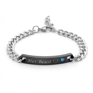 Detailed view of silver curb chain bracelet with Her Beast engraving and blue gemstone