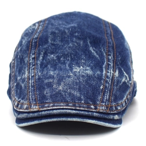 Close-up detail of vintage washed cotton denim beret with orange contrast stitching