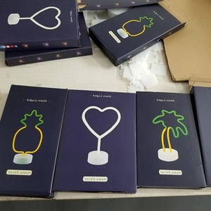 Neon LED Pineapple Heart and Palm Tree lights with white bases in home decor packaging