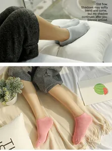 Detailed macro view of soft knit cotton ankle socks in light pink and grey tones