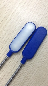Macro detail of two blue portable USB LED lamps with flexible gooseneck metal tubes