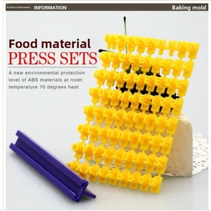 Close-up of food grade DIY alphabet cookie stamps set with purple handle for baking
