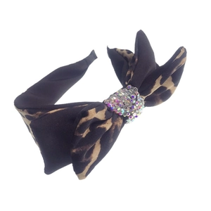 Leopard print headband featuring a large double-layered bow and sparkly rhinestone center