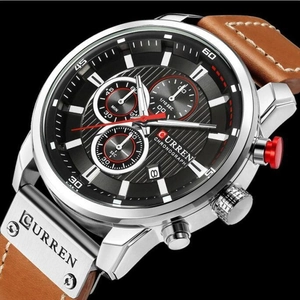 Macro detail of Curren chronograph dial with silver case and brown leather strap