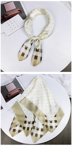 Detail of silk square scarf featuring yellow polka dots and brown plaid patterns