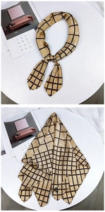 Detail of a ginger yellow checkered silk scarf with black and red grid patterns
