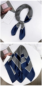Detailed view of navy blue polka dot silk scarf with elegant geometric border design