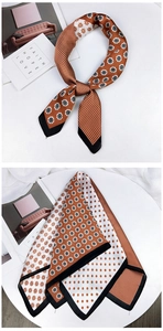 Detailed view of a vintage floral silk scarf with caramel orange accents and polka dots