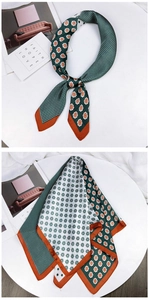 Detail of elegant retro square silk scarf with green and orange floral polka dot pattern