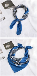 Detail of navy blue silk scarf with white polka dot pattern and stripe design