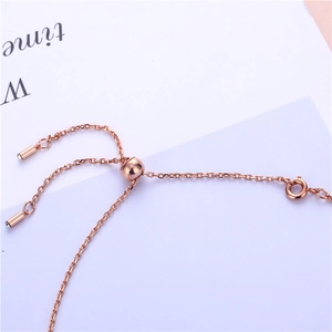 Close-up of rose gold adjustable sliding ball clasp and tiny rhinestone drop pendants