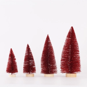 Set of four mini red sisal Christmas trees with rustic wood bases on white background