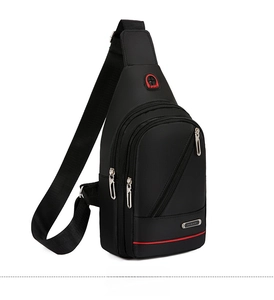 Detail view of black waterproof nylon sling bag with multiple zippers and earphone port