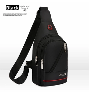 Detail of black waterproof oxford chest bag featuring a red stripe and headphone jack port