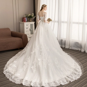 Elegant off-shoulder white lace wedding dress with long train and lace-up back