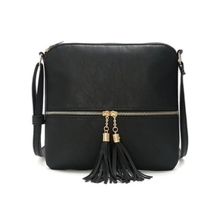 Detail shot of black crossbody bag featuring dual tassel zip pulls and gold hardware