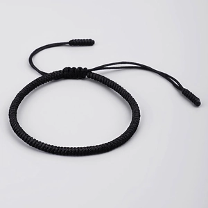 Detailed view of a handmade black braided knot bracelet with adjustable sliding closure