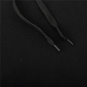 Macro view of flat woven drawstrings with reinforced tips on black fleece hoodie