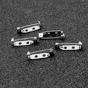 Macro detail of five silver stainless steel safety brooch pins for DIY jewelry making