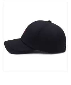 Close-up of a black cotton baseball cap showing side profile and shield emblem detail