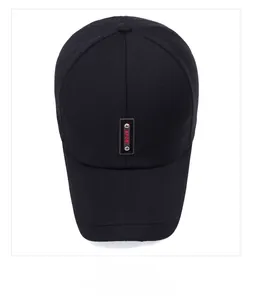 Detailed top view of a black baseball cap with a red Sport label and decorative rivets