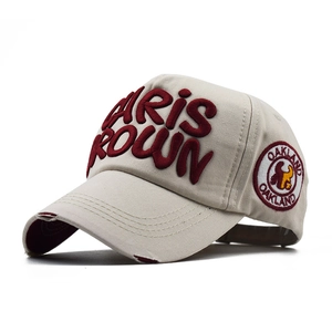 Detail of beige cotton baseball cap with 3D Chris Brown embroidery and distressed brim