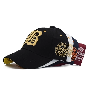Detail of multi-colored cotton baseball caps with 3D golden B embroidery and side patch