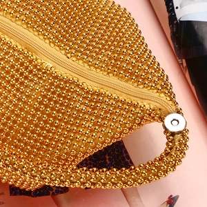 Elegant gold beaded evening clutch bag with woven metallic beads and zipper closure