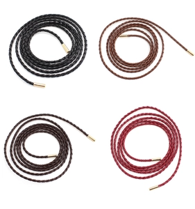 Close-up of four colors of braided PU leather waist belts with gold metal tips