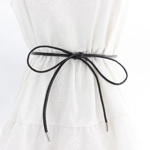 Minimalist black slim waist belt with silver metal tips on floral dress