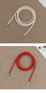 Detail of round thin waist ropes with silver metal aglets in cream and red colors