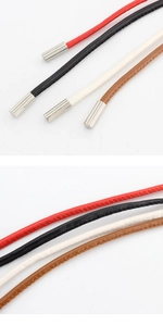 Detail of slim waist cord belt with metal end caps in red, black, white, and brown