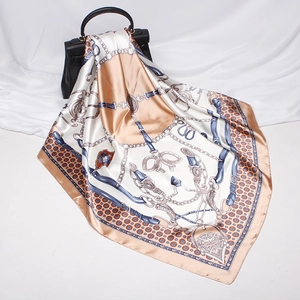 Detailed view of beige and blue satin square scarf with classic horse harness chain patterns