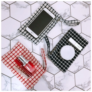 Three-piece set of plaid fabric storage pouches with zipper and handles for small items