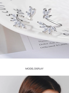 Macro detail of silver leaf earrings with marquise-cut cubic zirconia and refined craftsmanship