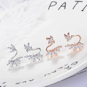 Elegant floral zircon stud earrings in silver and rose gold finish on a white plate